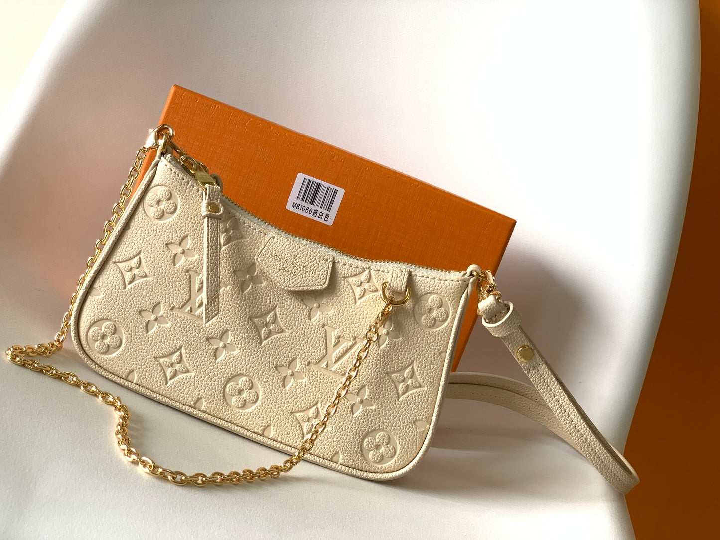 Louis Vuitton Elegant Cream Embossed Vegan Leather Underarm Bag with Gold Chain