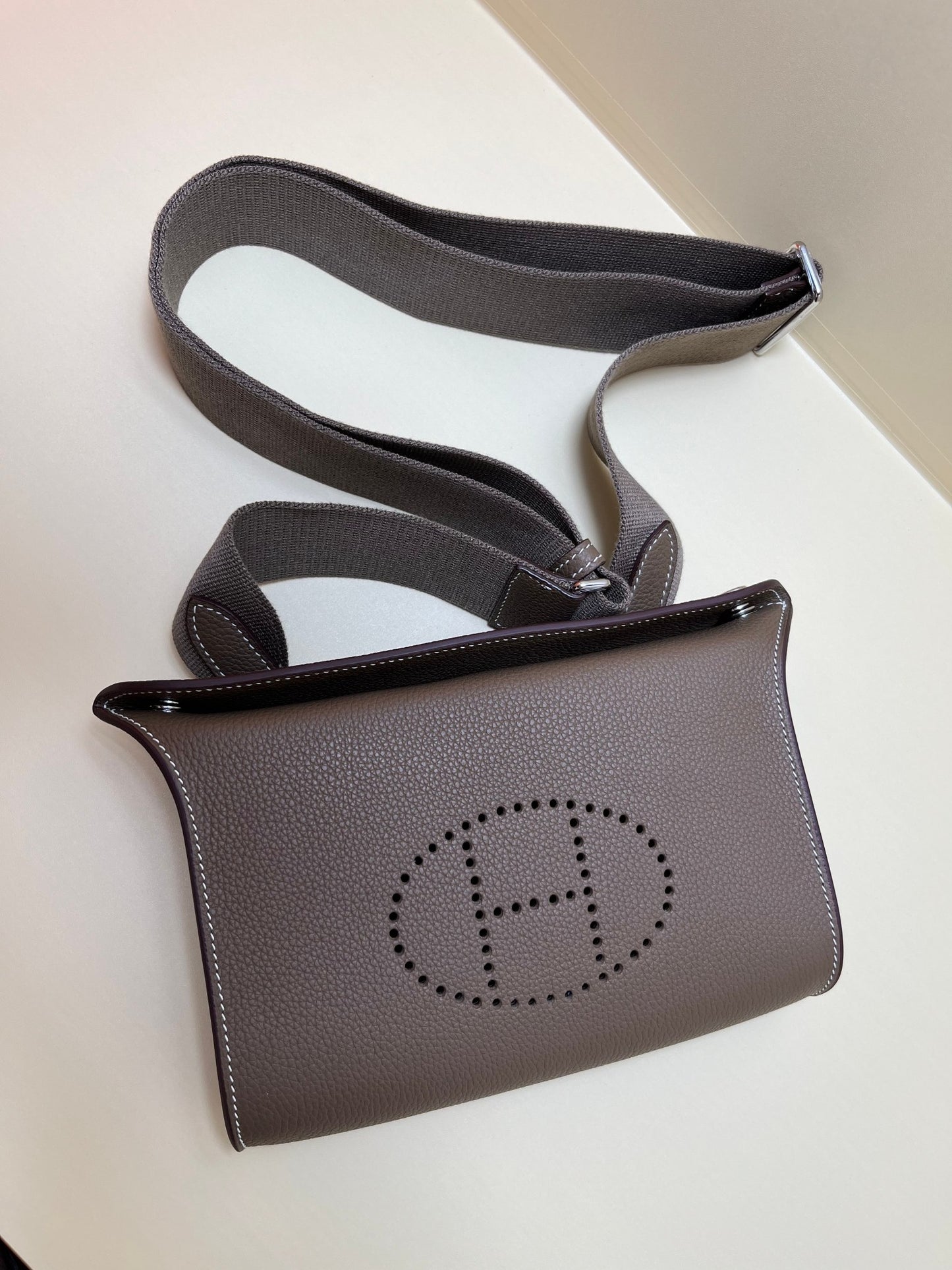 Luxury Pebbled Leather Crossbody Bag with Perforated H Logo - Taupe