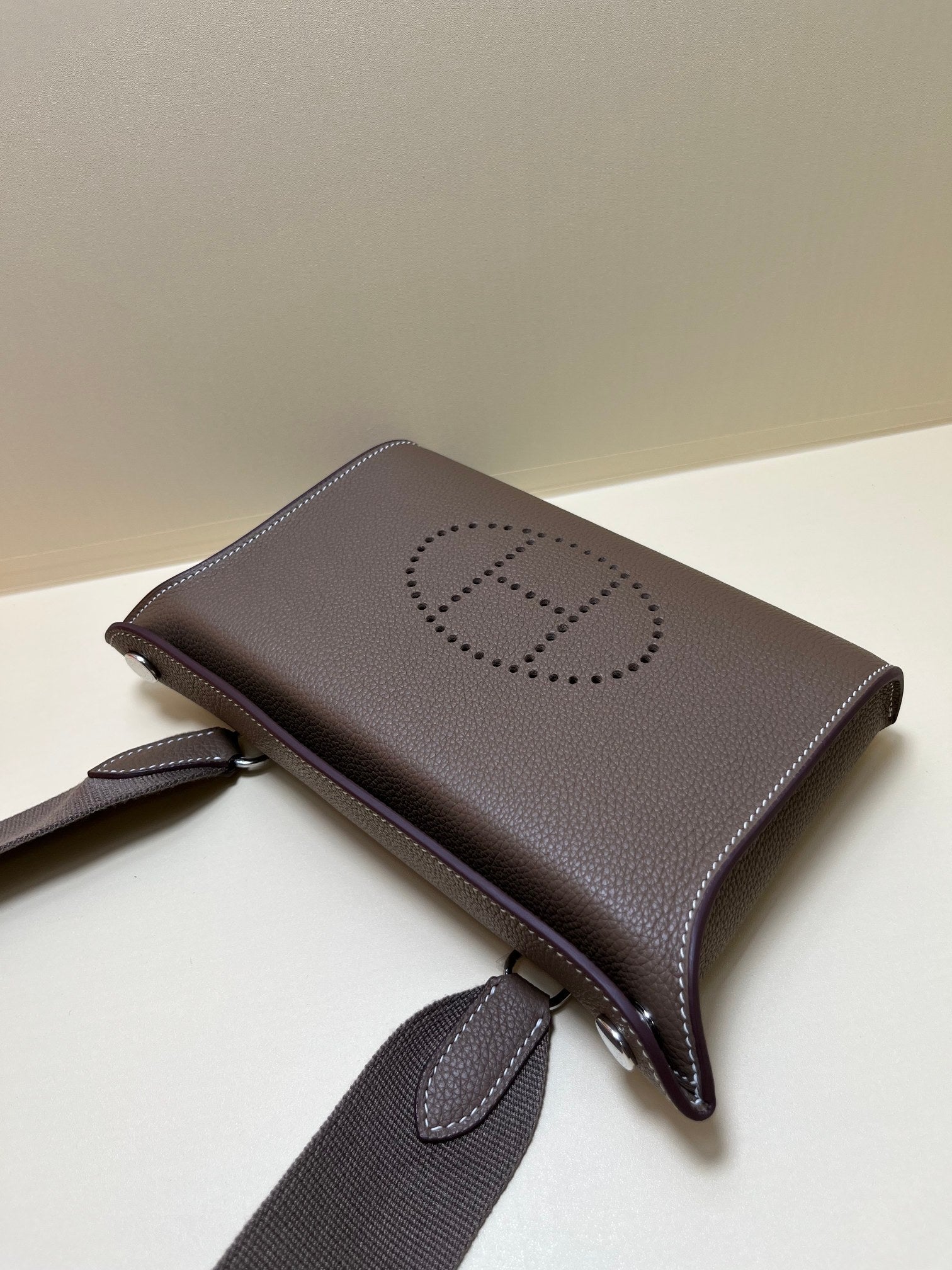 Luxury Pebbled Leather Crossbody Bag with Perforated H Logo - Taupe