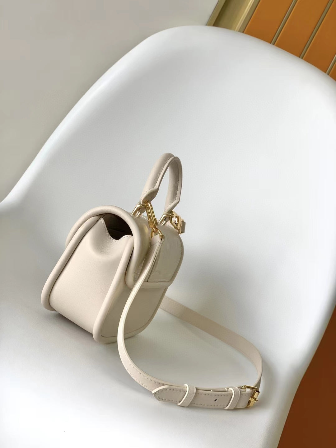 Louis Vuitton Elegant Beige Mini Top Handle Bag with Gold Lock Clasp