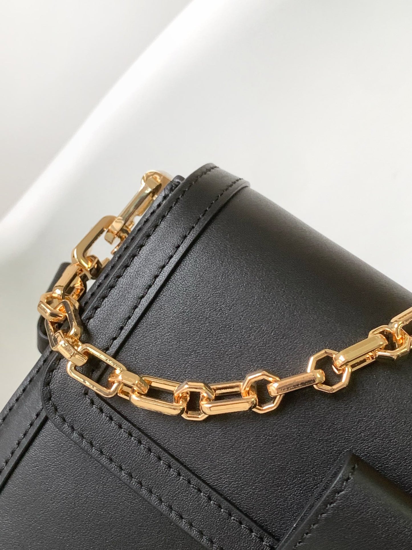 Louis Vuitton Elegant Black Faux Leather Crossbody Bag with Gold Chain Strap