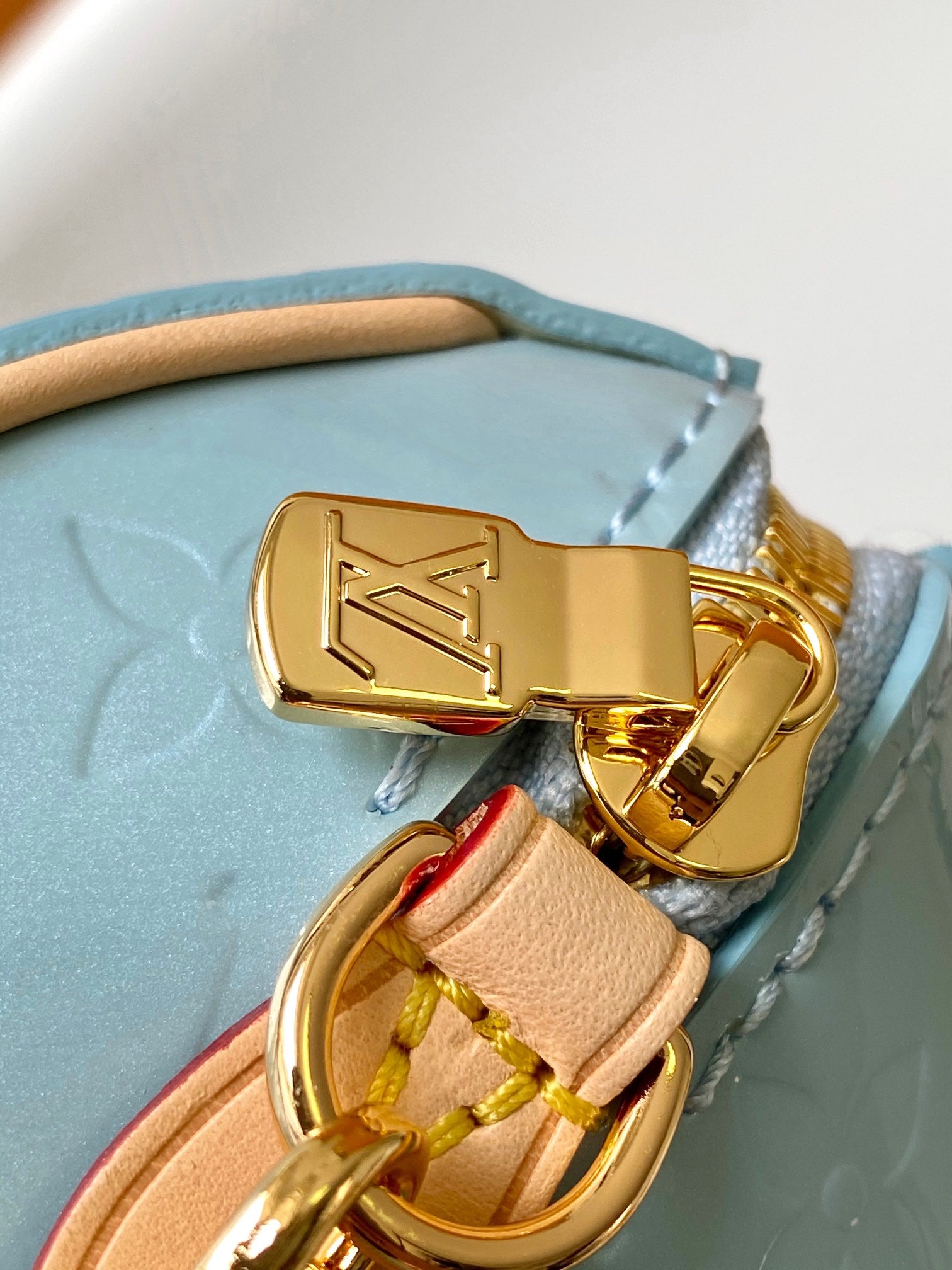 Louis Vuitton Pastel Blue Embossed Crossbody Barrel Bag with Gold Chain and Heart Charm