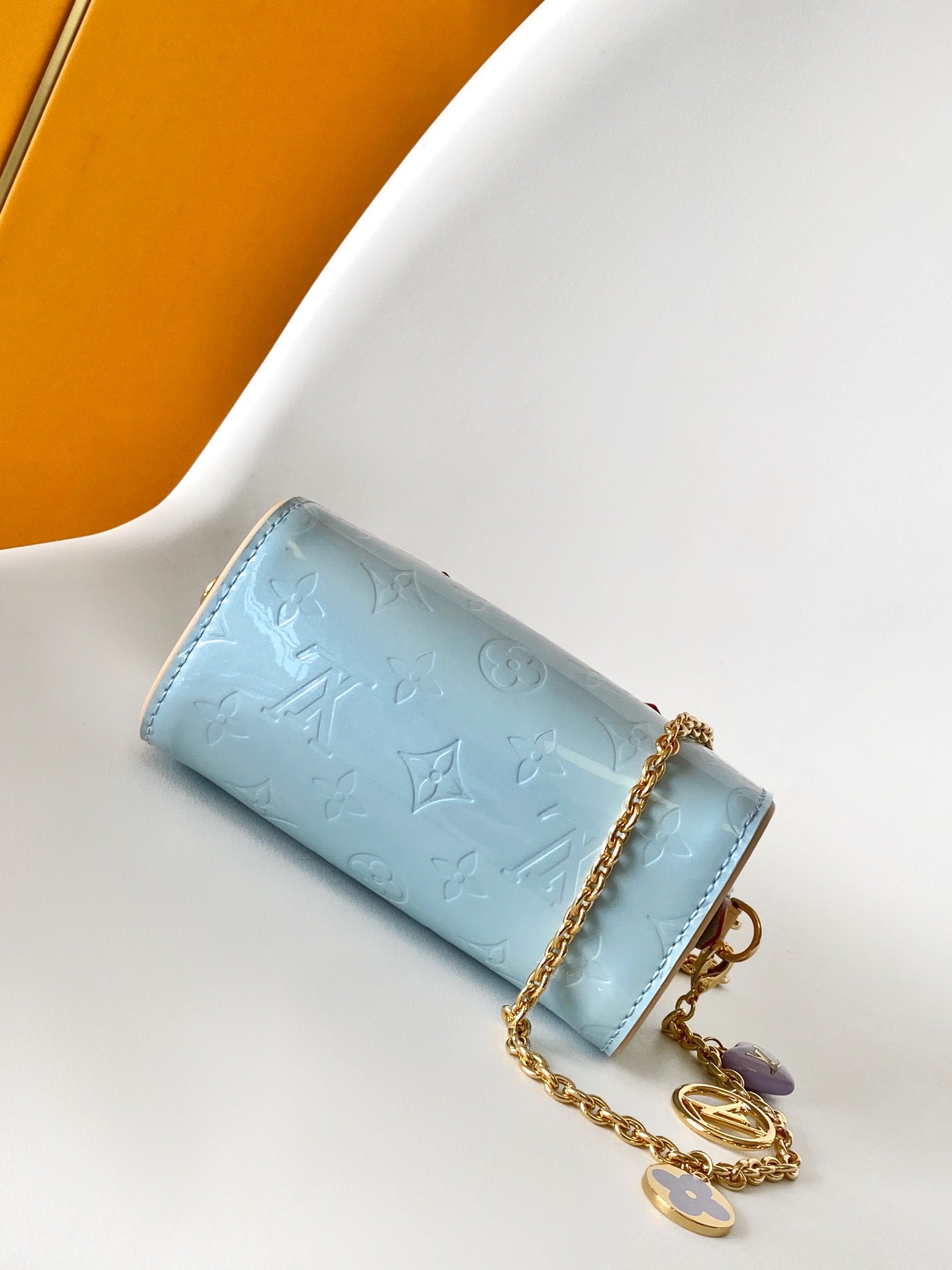 Louis Vuitton Pastel Blue Embossed Crossbody Barrel Bag with Gold Chain and Heart Charm