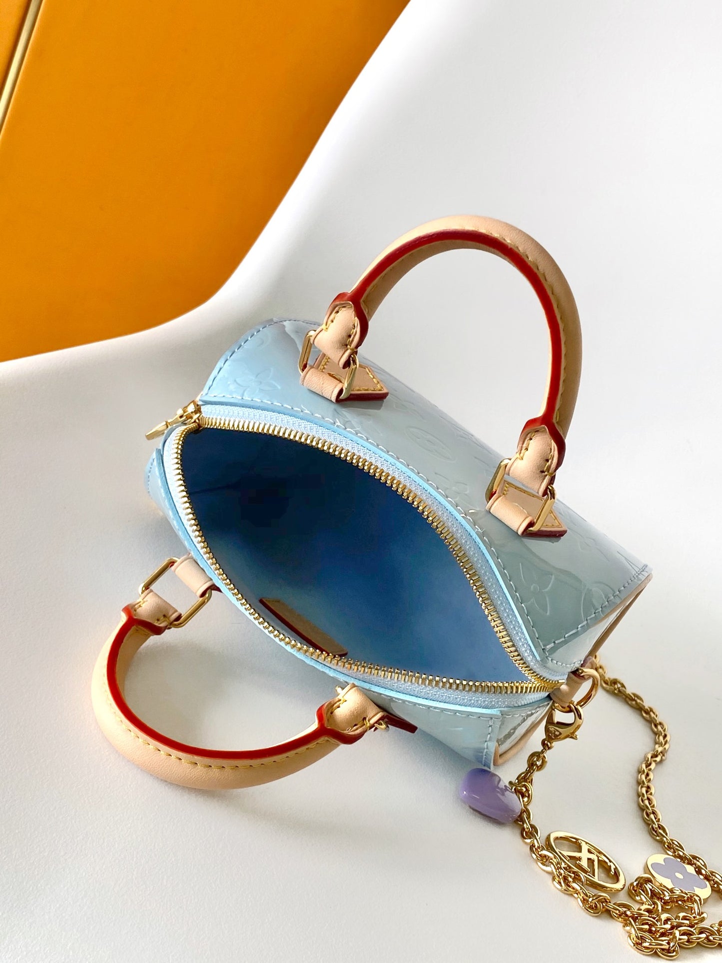 Louis Vuitton Pastel Blue Embossed Crossbody Barrel Bag with Gold Chain and Heart Charm