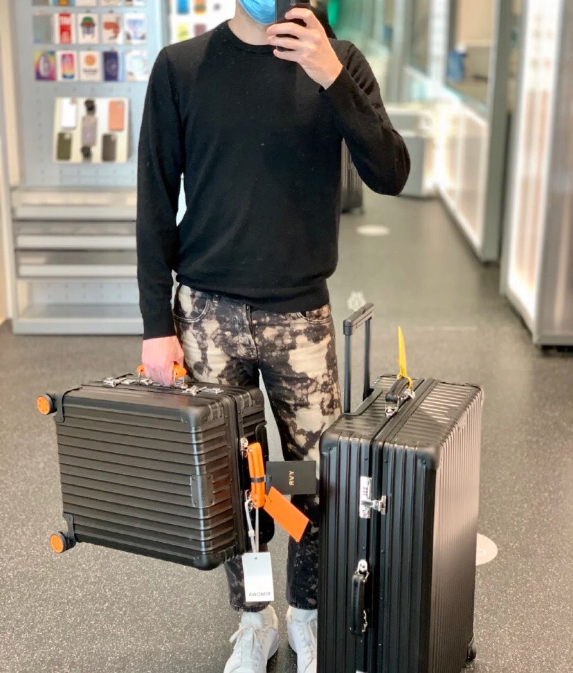Matte Black Hardshell Spinner Suitcase with Orange Handles and Wheels