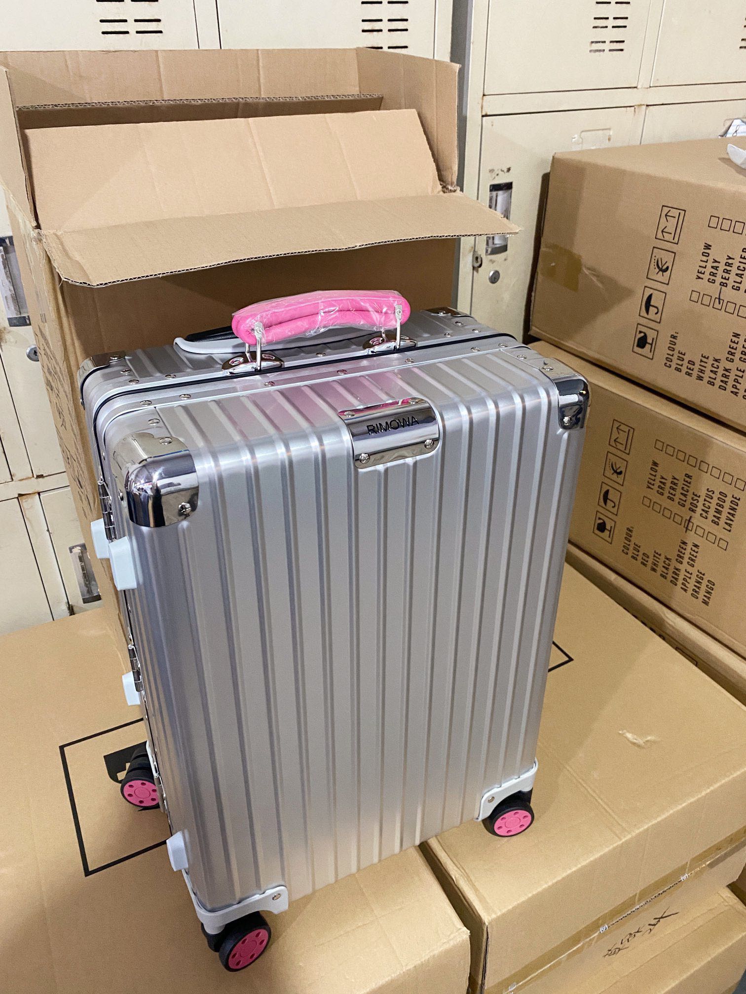 Silver Hardside Spinner Luggage with Pink Wheels and Handle