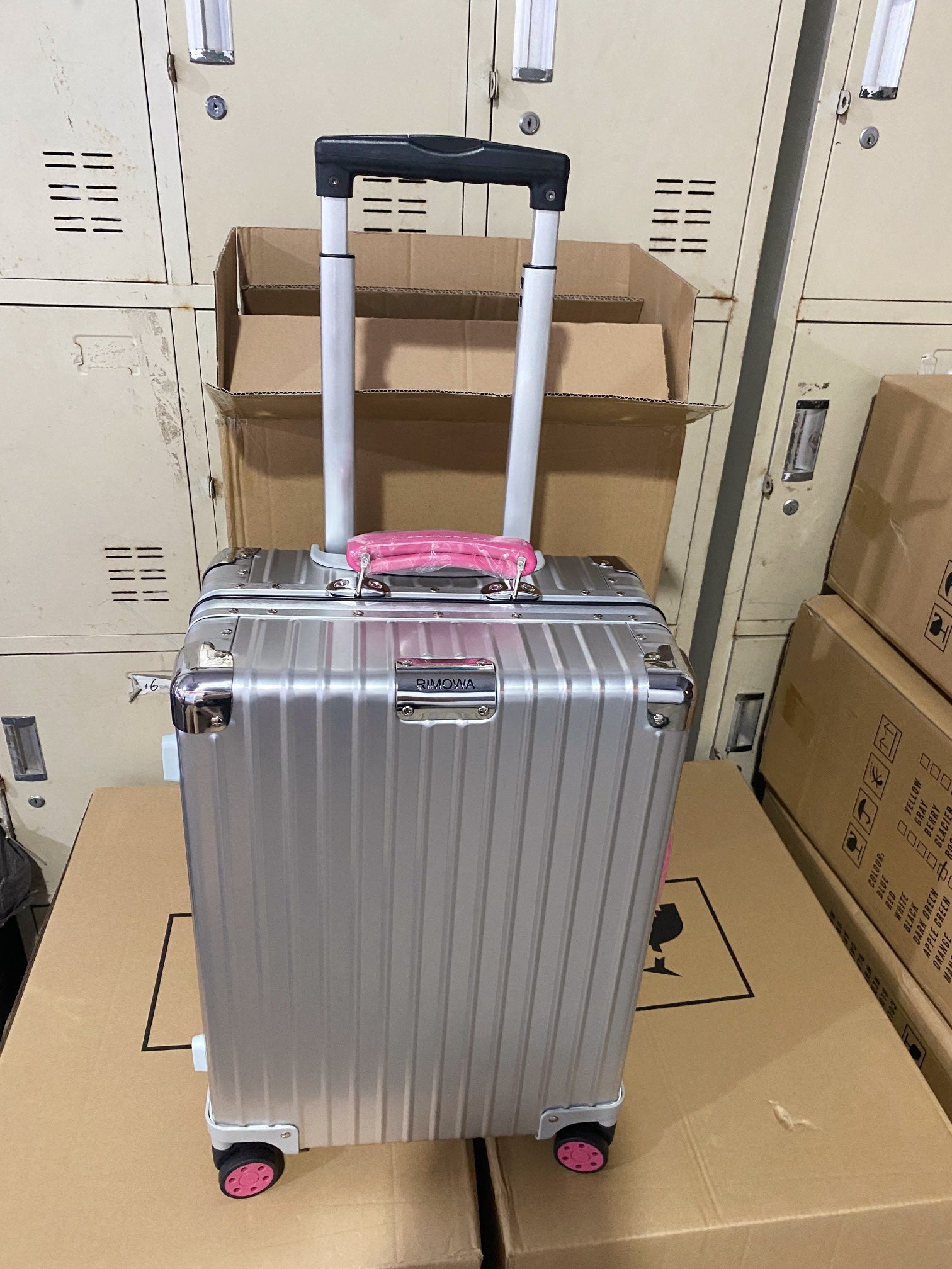 Silver Hardside Spinner Luggage with Pink Wheels and Handle