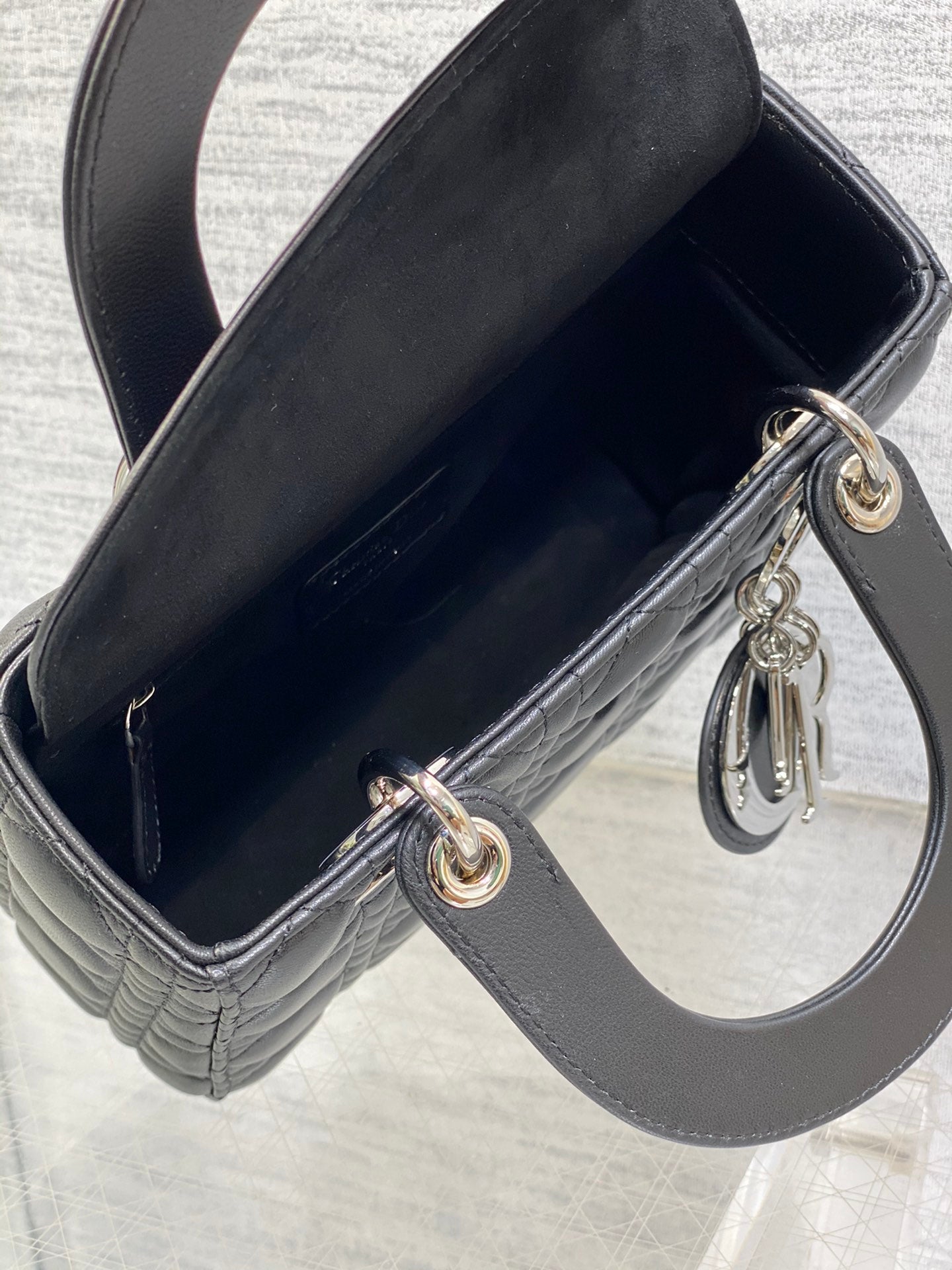 Dior Elegant Black Quilted Leather Handbag with Top Handles and Strap