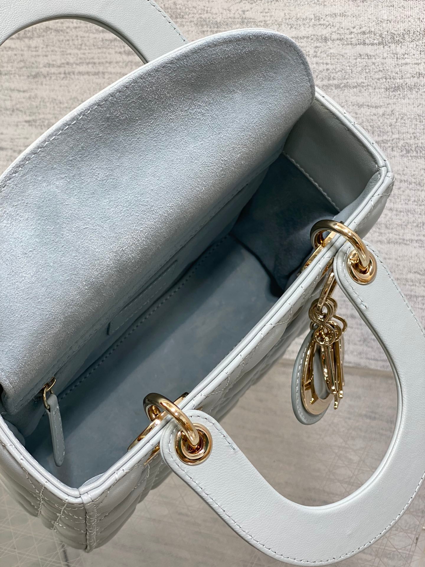 Dior Elegant Light Blue Quilted Leather Handbag with Crossbody Strap