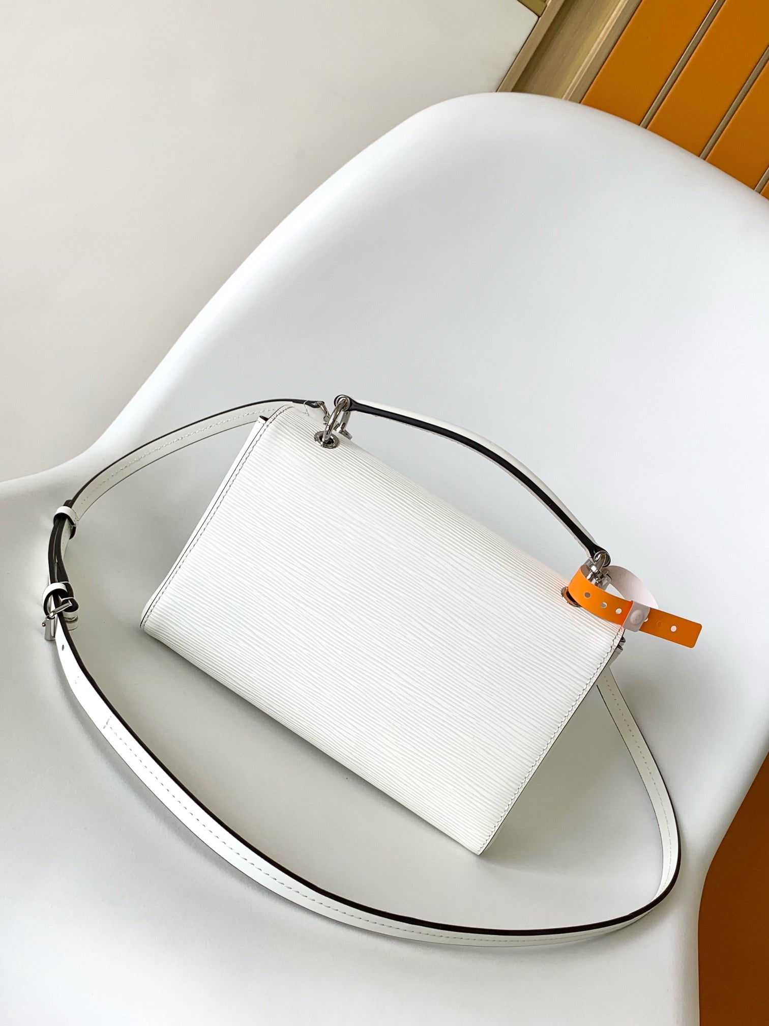 Louis Vuitton Elegant White Textured Leather Handbag with Top Handle and Strap
