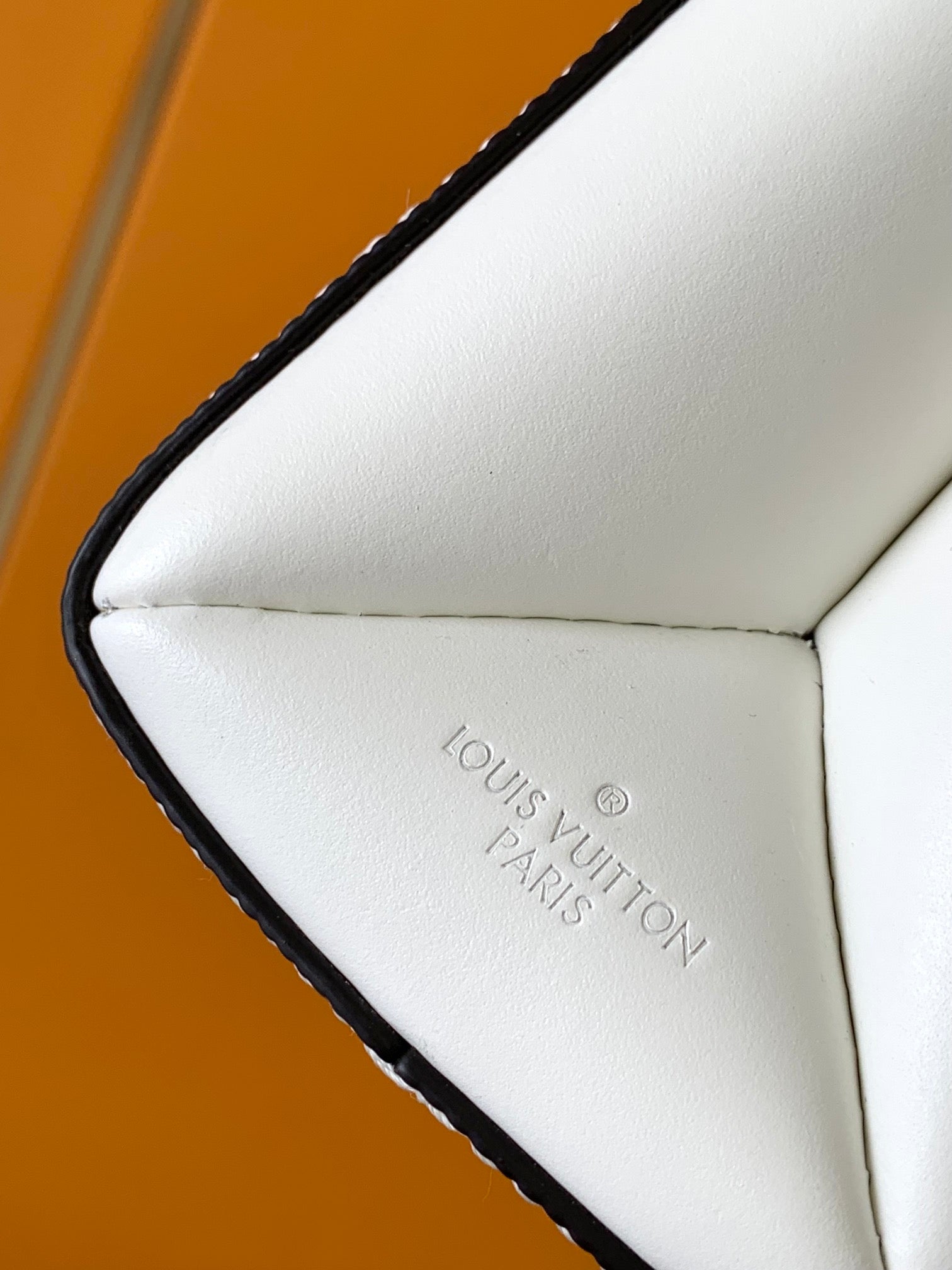 Louis Vuitton Elegant White Textured Leather Handbag with Top Handle and Strap