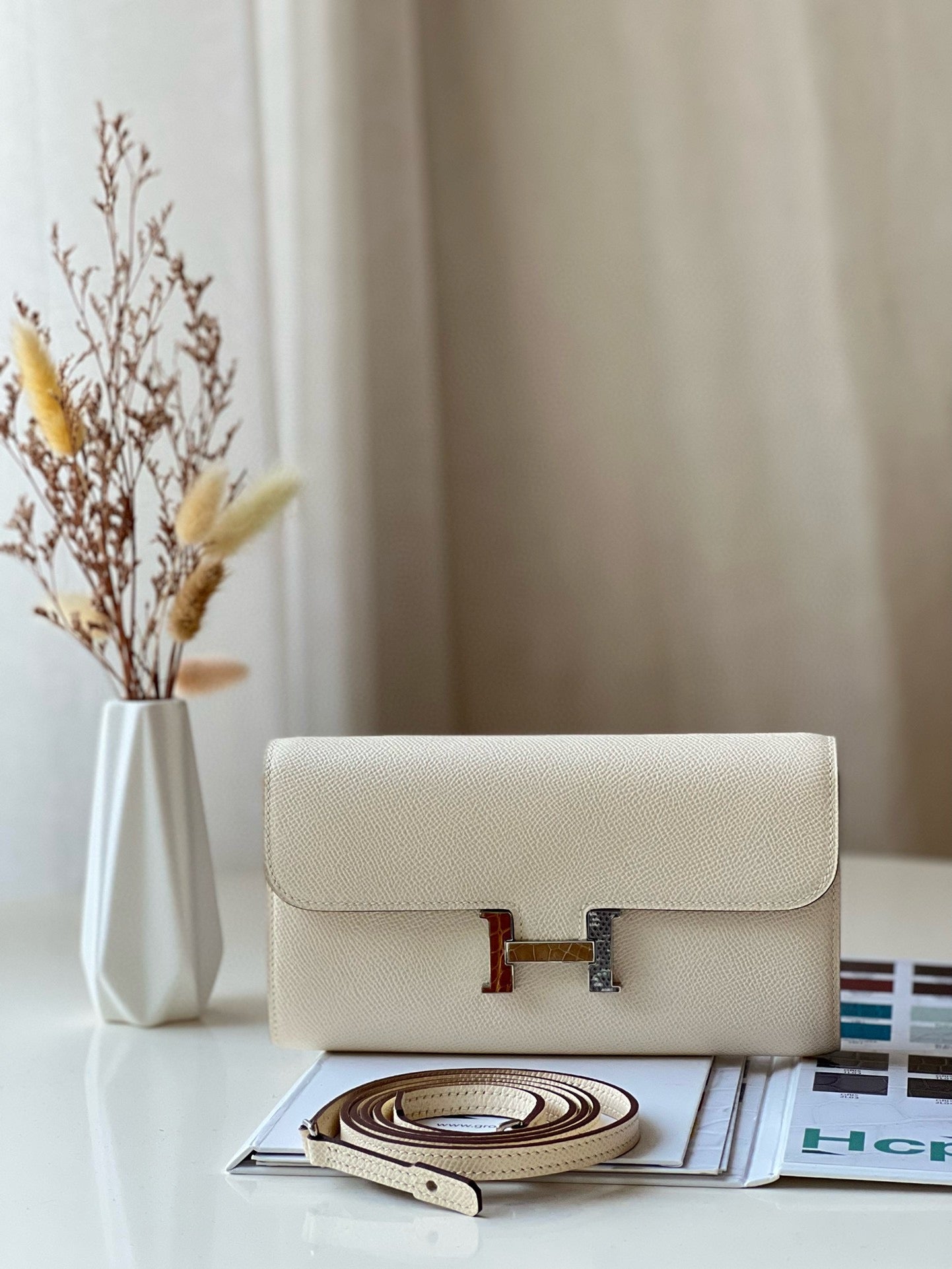 Elegant Cream Leather Crossbody Bag with Gold H-Logo Clasp
