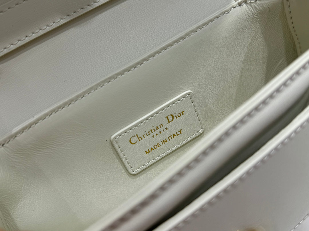 Luxury White Leather Top Handle Handbag with Gold-Tone Signature Logo and Adjustable Strap