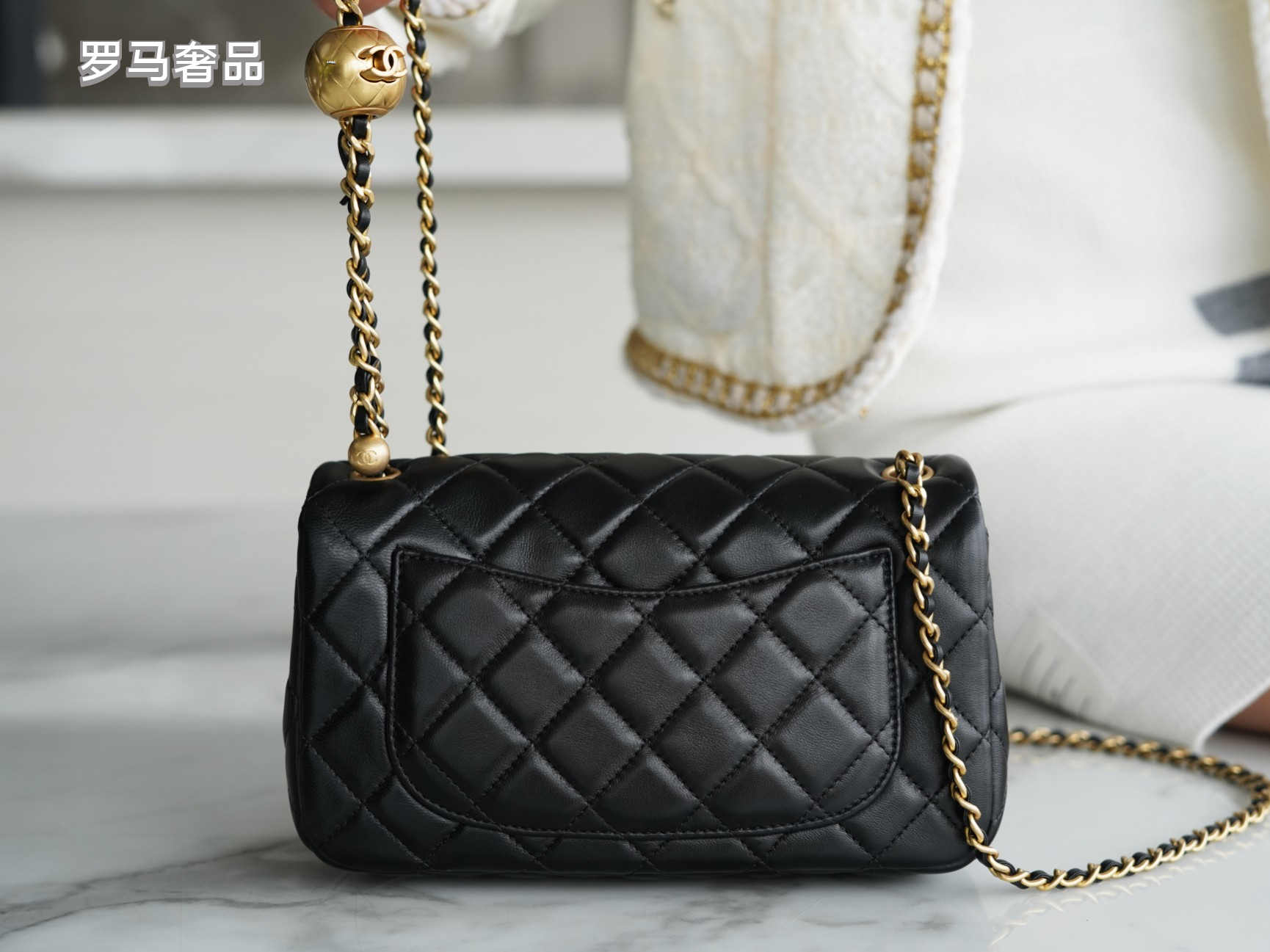 Luxury Quilted Black Leather Mini Flap Bag with Gold-Tone Chain and Ball Detail