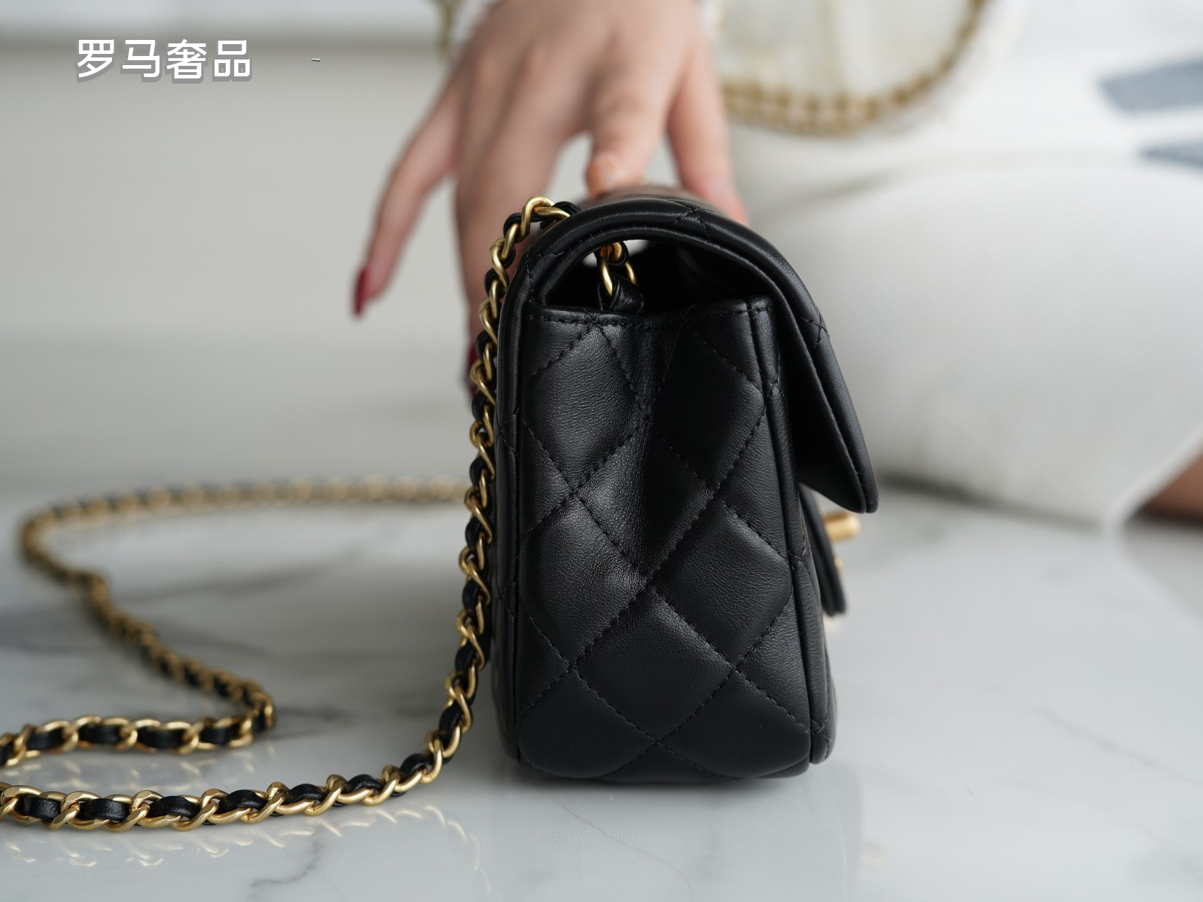 Luxury Quilted Black Leather Mini Flap Bag with Gold-Tone Chain and Ball Detail